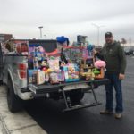 Zach Edwards KVC Kansas Holiday Hero picture with gifts 