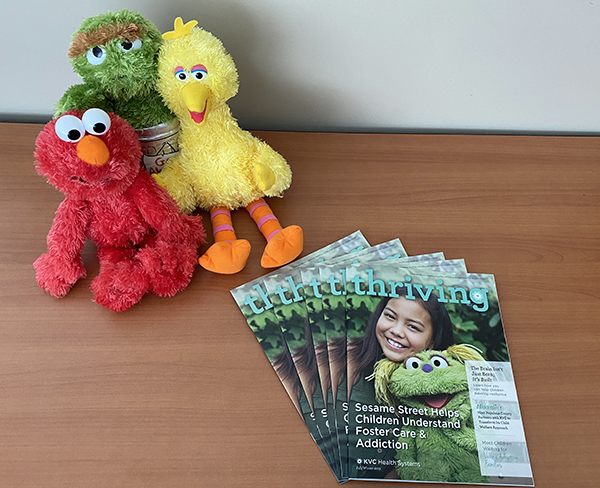 KVC Health Systems Thriving magazine with Sesame Street characters Elmo, Big Bird and Oscar