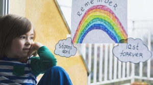 Child feels hopeful thinking of the rainbow after the storm