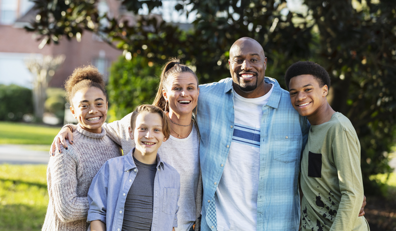 Portrait of blended multi-ethnic family, three children on kvc matching gift webpage