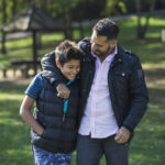 Father and son in public park