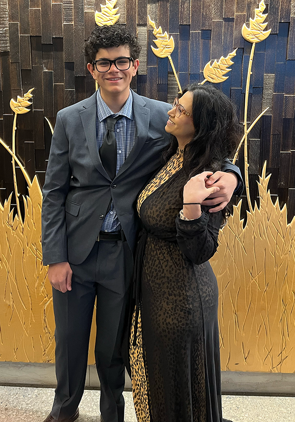 Danya smiles with pride looking at her son. She has been on an unstoppable journey, from foster care to law school.