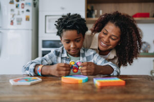 Mother playing with autistic son
