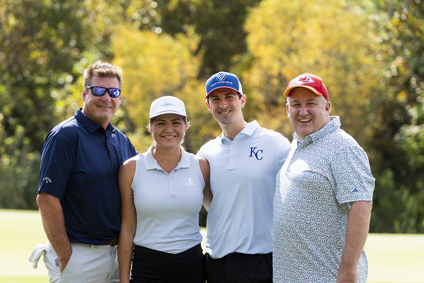 Four members of the UMB Bank golf team, second-place winners of the 2026 KVC Kids Classic, pose together on the golf course.